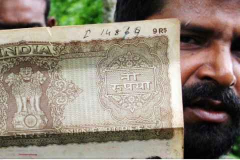 A resident shows a land ownership document issued by Indian authorities at the Dashiarchhara Indian enclave in June 2004