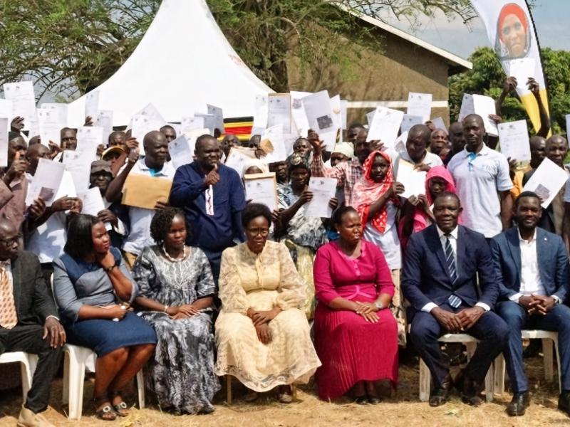 uganda Beneficiaries of Certificate of Customary Ownership pose for a photo with the Minister of Lands, Housing and Urban Development, Hon Judith Nabakooba in Butaleja disrtict.jp