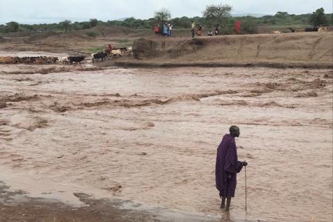 Maasai herder on the flooded Mundarara road, northern Tanzania